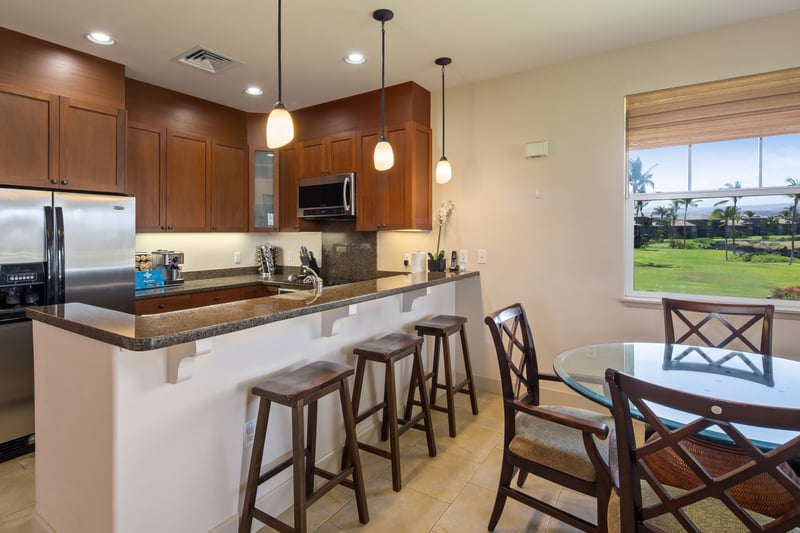 Modern island kitchen with open flow to the dining area and beautiful garden views