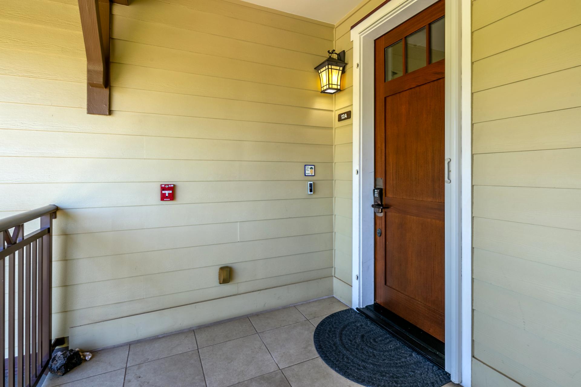 Welcoming entryway with keypad lock, lantern light, and unit 12A.