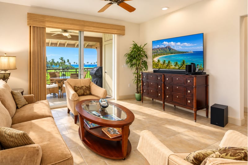 A flat screen TV, ceiling fan, and sliding glass doors connect your living area to the lanai for easy indoor-outdoor living. HLI-12A