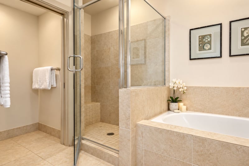 A closer look at your primary bathroom shows the tub and shower, with vanity storage and LAFORRÉ amenities within easy reach. HLI-12A