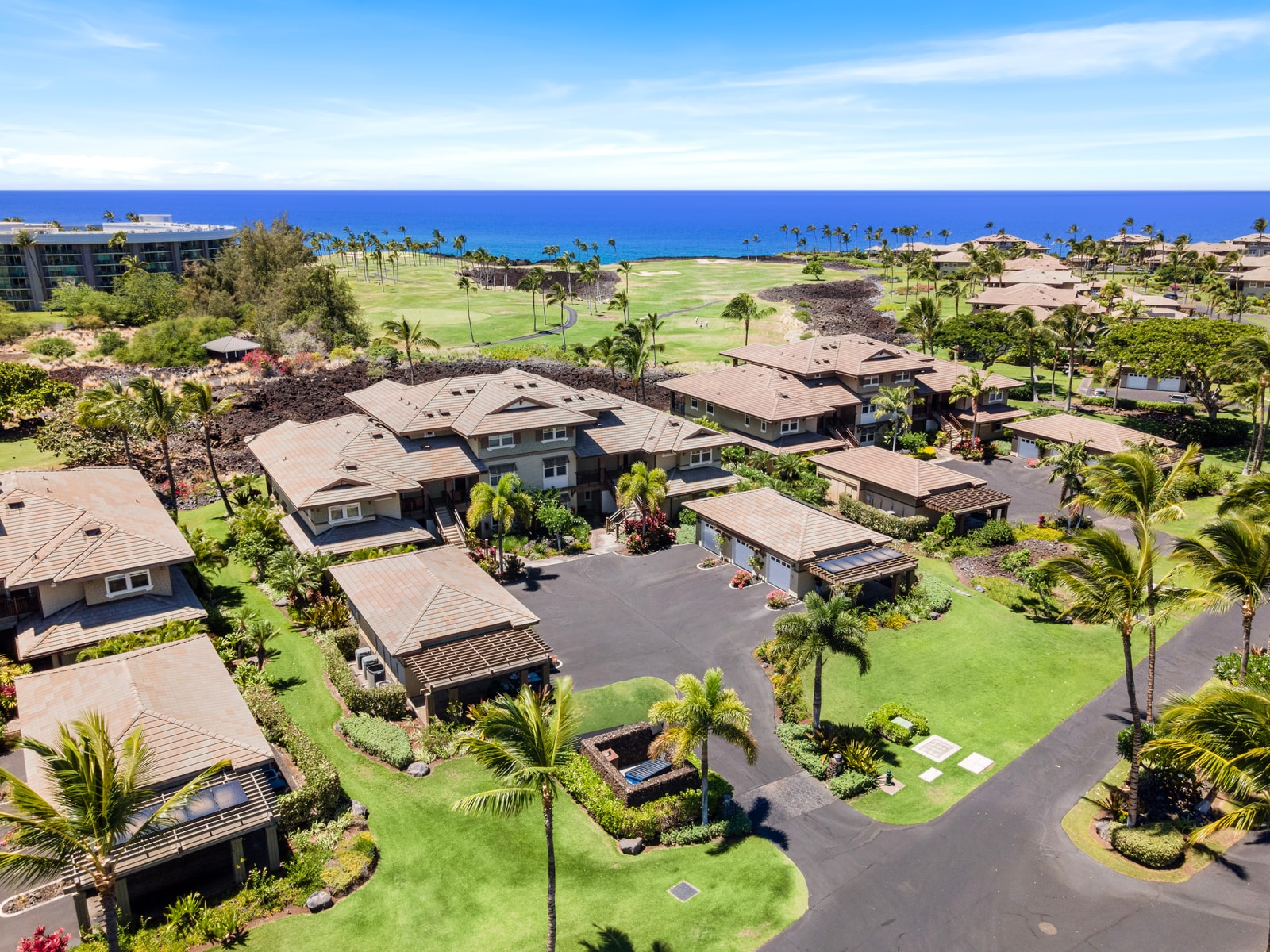 Bird’s-eye look at the community reveals manicured paths, tropical landscaping, and proximity to the coast.
