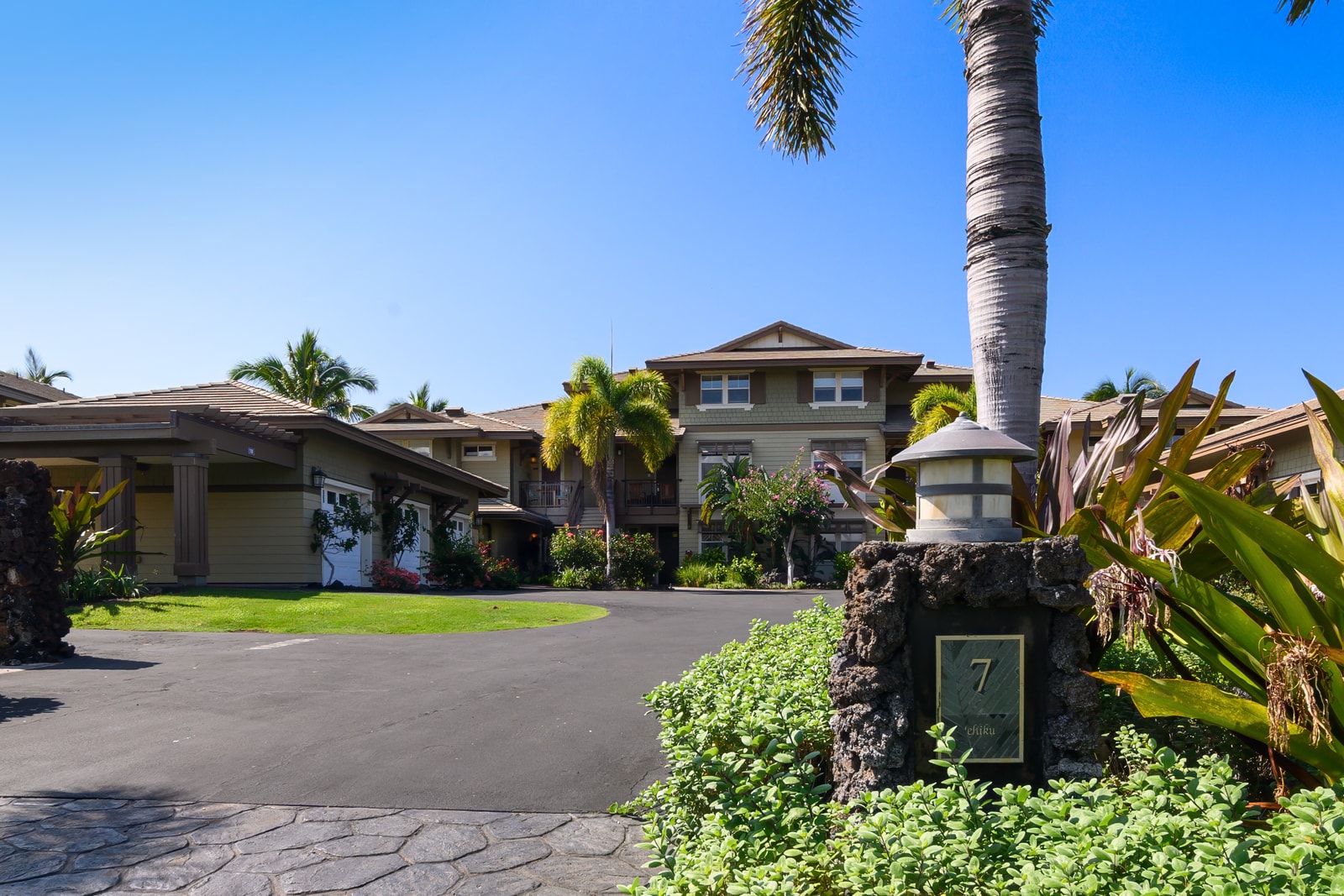 The exterior view of the villa surrounded by tropical landscaping