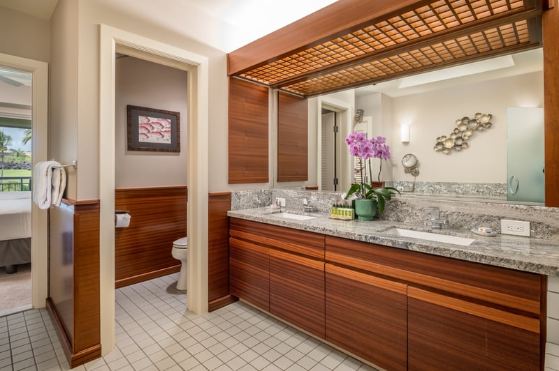 Impeccably clean guest bathroom with dual sinks and a large vanity for easy mornings.