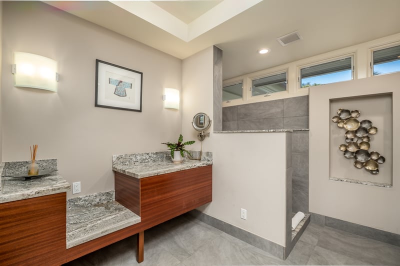 Get ready in luxury with expansive counters and rich, warm wooden cabinetry.