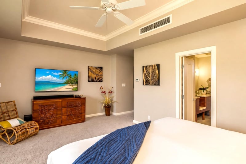 Spacious primary suite complete with beautiful tray ceilings and a flat-screen TV.