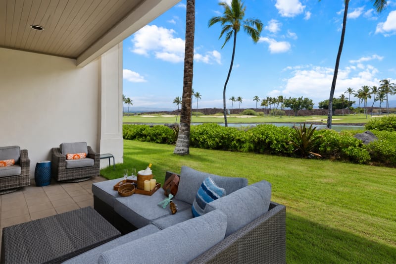 Relax on the covered lanai with comfortable seating and stunning tropical views.