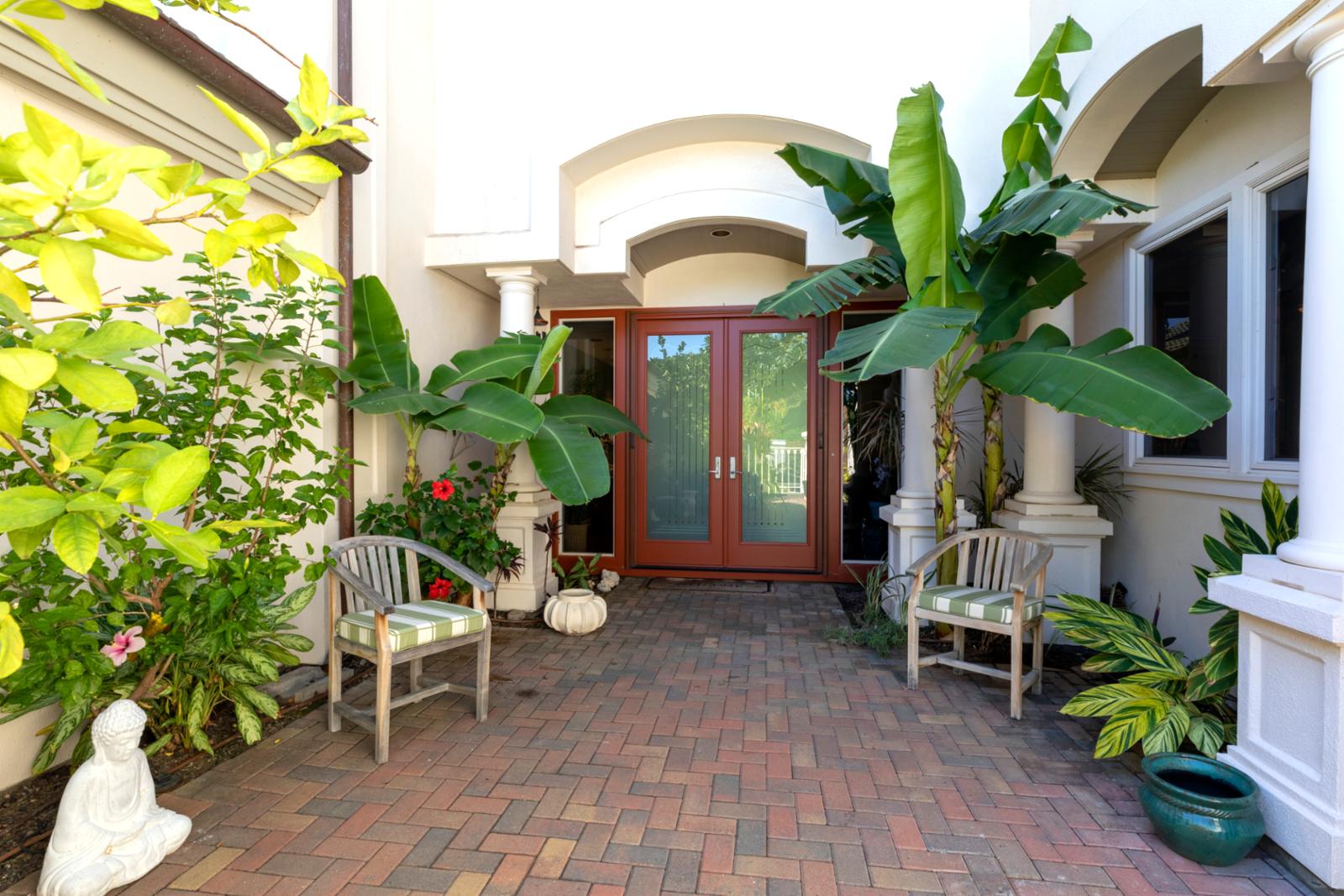 Framed by palms and flowers, this entry sets the tone for luxury