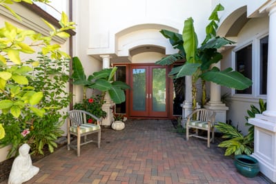 Framed by palms and flowers, this entry sets the tone for luxury