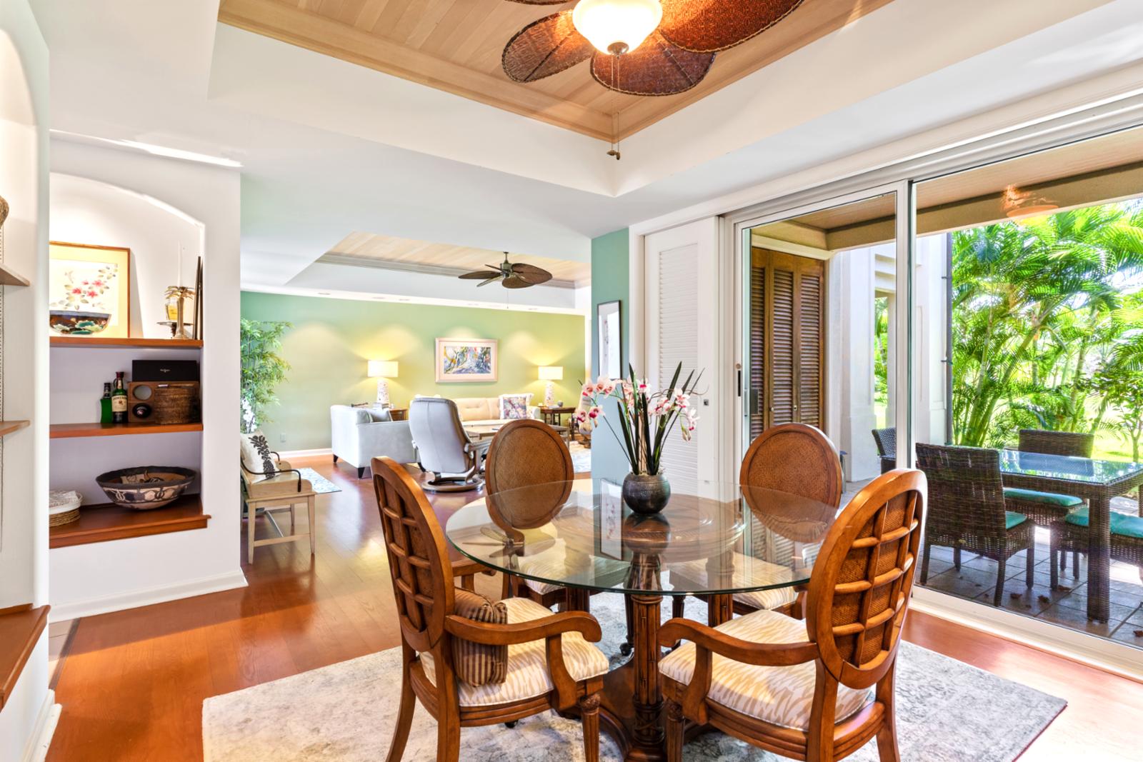 Elegant tropical dining room opens to lush lanai and greenery.