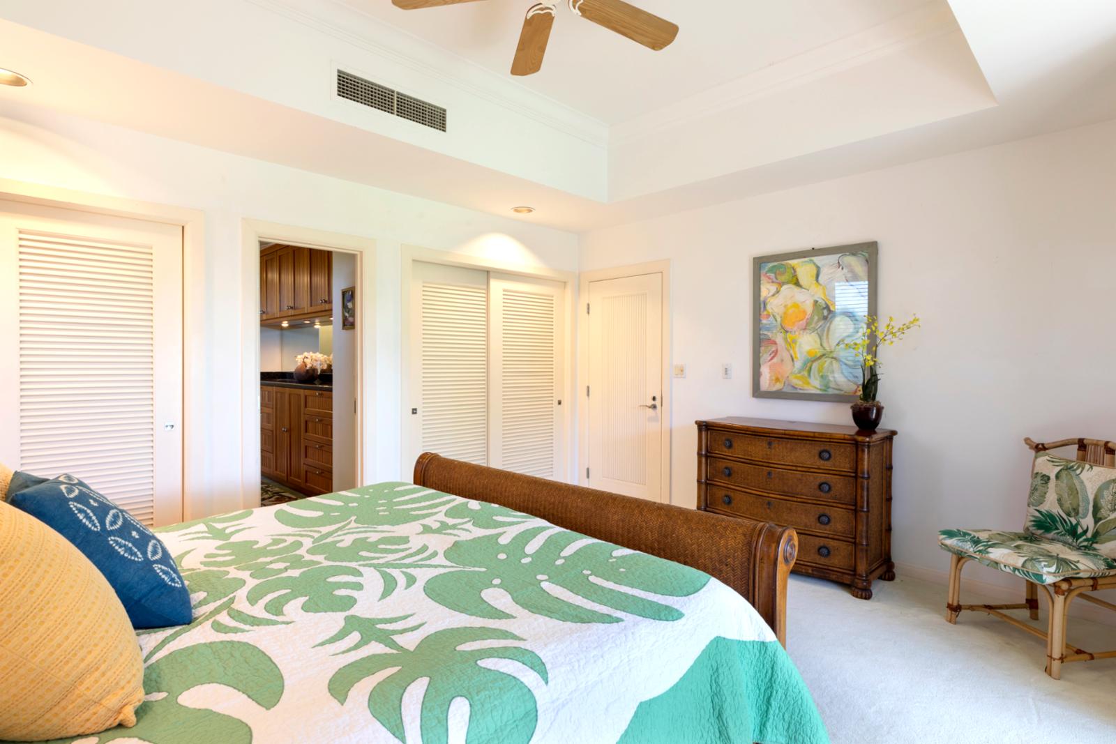 Soothing tones and tropical flair in a sunlit room made for rest, comfort, and relaxation