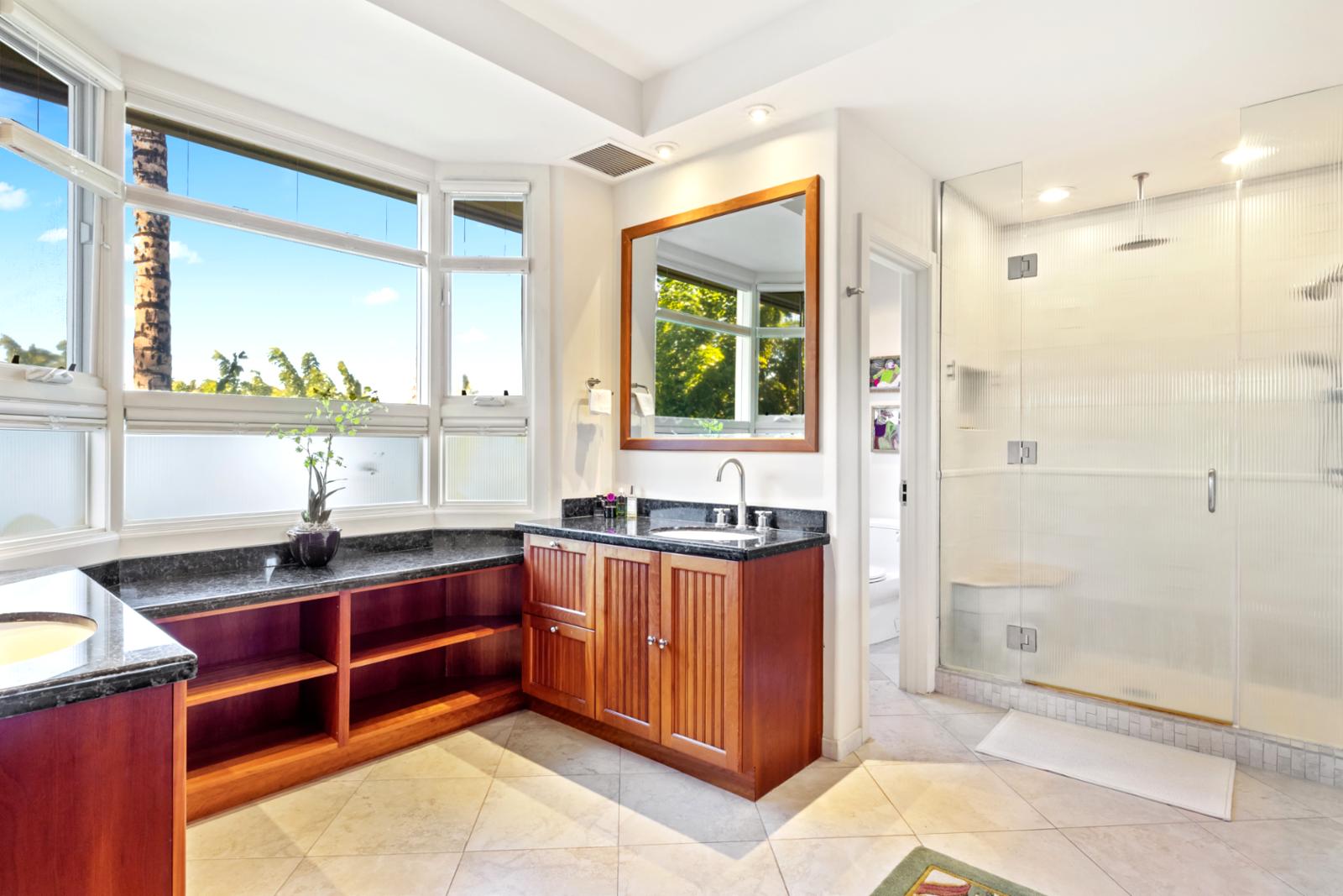 Soak, steam, and shine in this serene bathroom retreat with a built-in tub and sleek glass shower