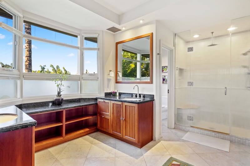 Soak, steam, and shine in this serene bathroom retreat with a built-in tub and sleek glass shower