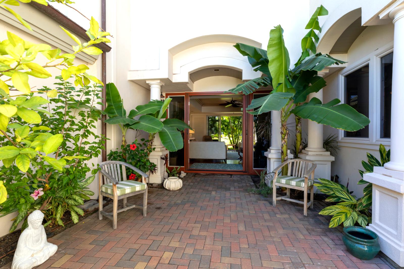 Soothing greenery and stylish columns create a warm welcome