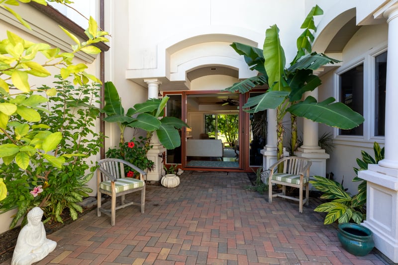 Soothing greenery and stylish columns create a warm welcome