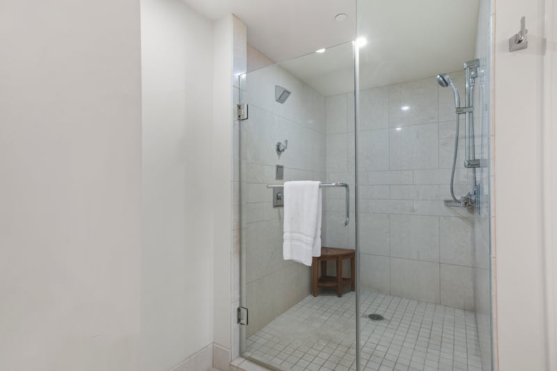Contemporary walk-in shower with luxury L'Occitane bath amenities.

