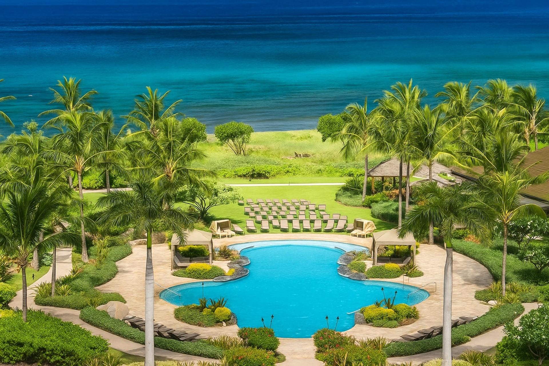 Oceanfront infinity-edge pool framed by tropical palms and lush gardens—your Maui resort escape starts here