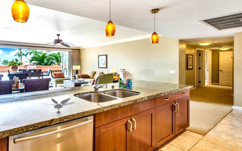 Natural light, granite countertops, and golden wood tones—kitchen dreams delivered
