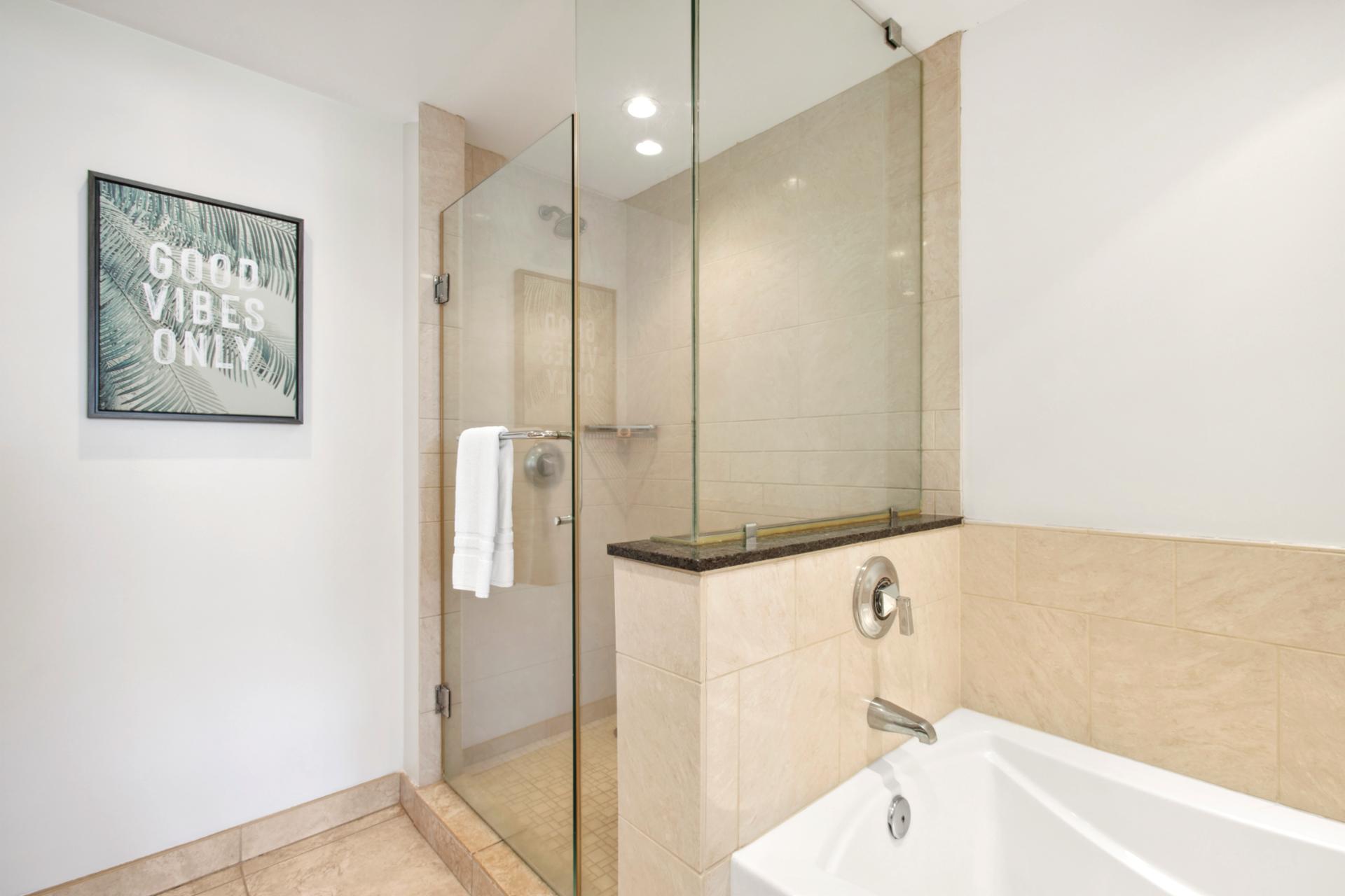 Feel the stress melt away in a soaking tub framed by natural tones—or take the glass-door shower for a quicker refresh