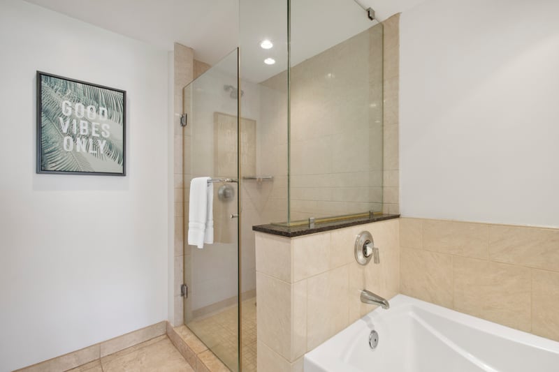 Feel the stress melt away in a soaking tub framed by natural tones—or take the glass-door shower for a quicker refresh