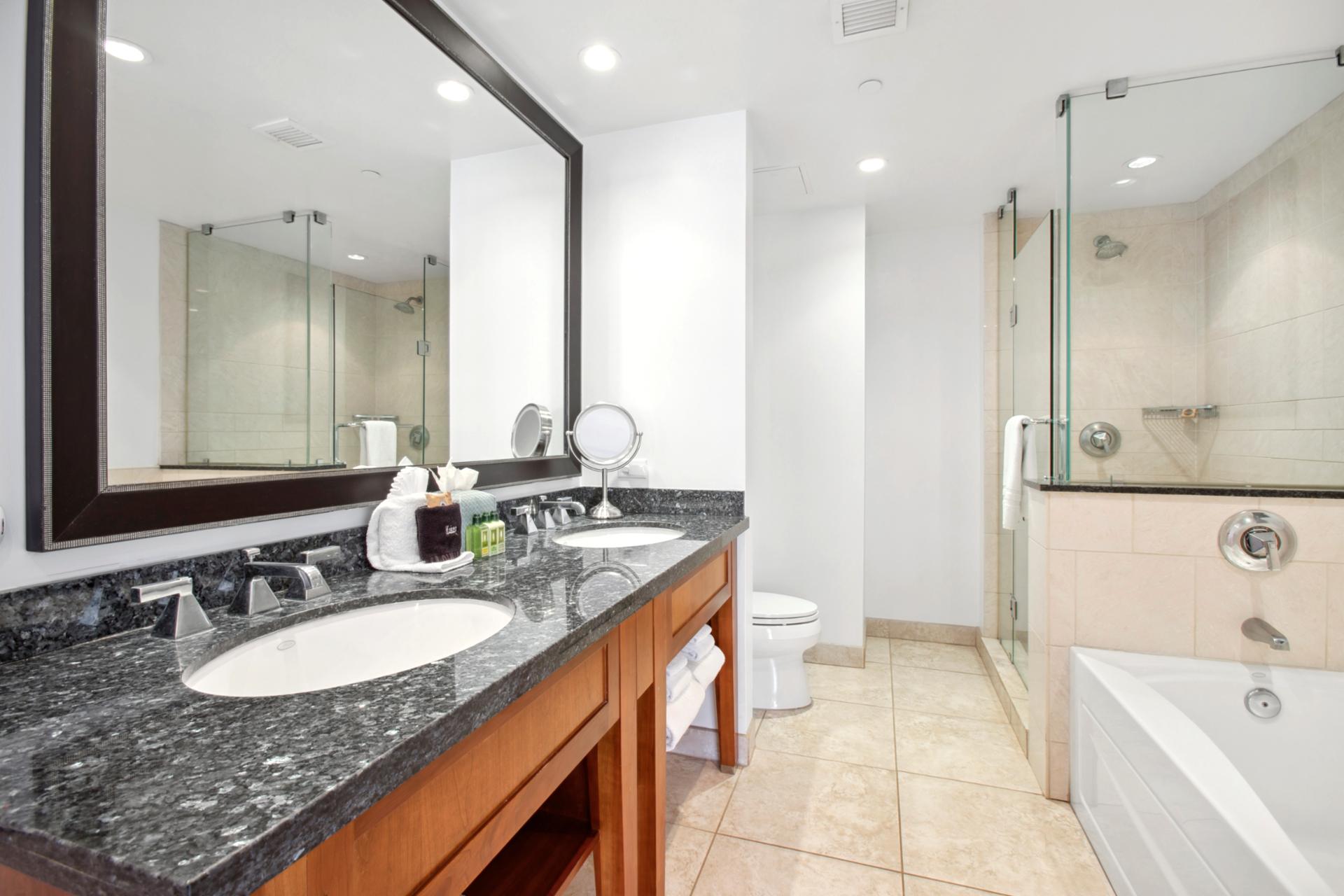 Elegant bathroom oasis with double sinks, walk-in shower, and tub