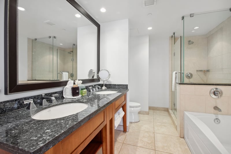 Elegant bathroom oasis with double sinks, walk-in shower, and tub