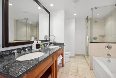 Elegant bathroom oasis with double sinks, walk-in shower, and tub