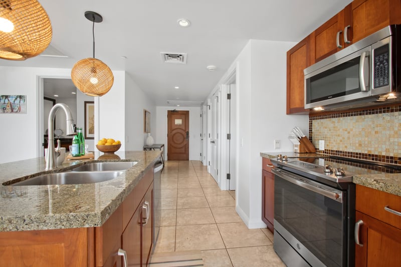 Modern kitchen entryway welcomes you home with warmth and island style