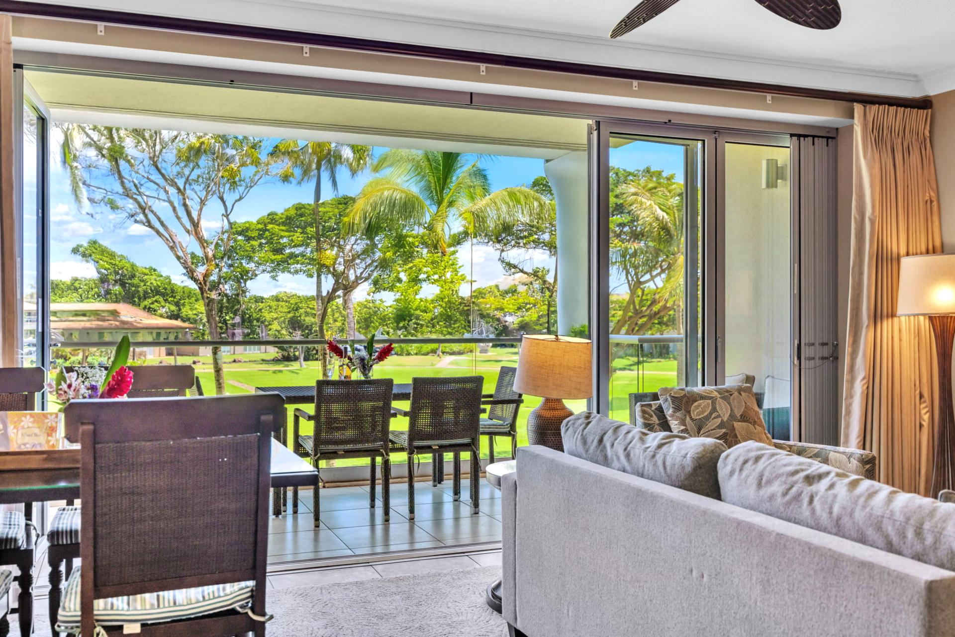 Bright, open living area with a sofa sleeper and direct lanai access for easy indoor-outdoor flow.