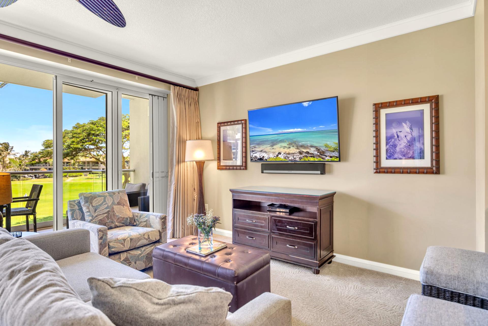 Living area with 65" Smart TV and sofa sleeper, ideal for movie nights after a day on the beach.