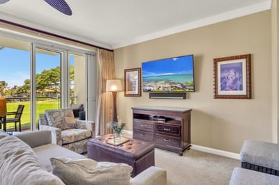 Living area with 65" Smart TV and sofa sleeper, ideal for movie nights after a day on the beach.