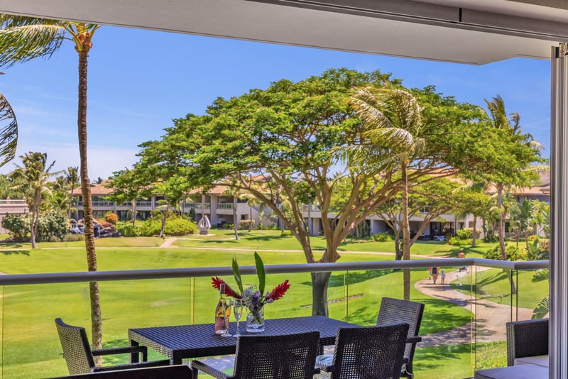 Shaded lanai with table and garden views—perfect for casual meals or peaceful afternoons outdoors.