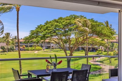 Shaded lanai with table and garden views—perfect for casual meals or peaceful afternoons outdoors.