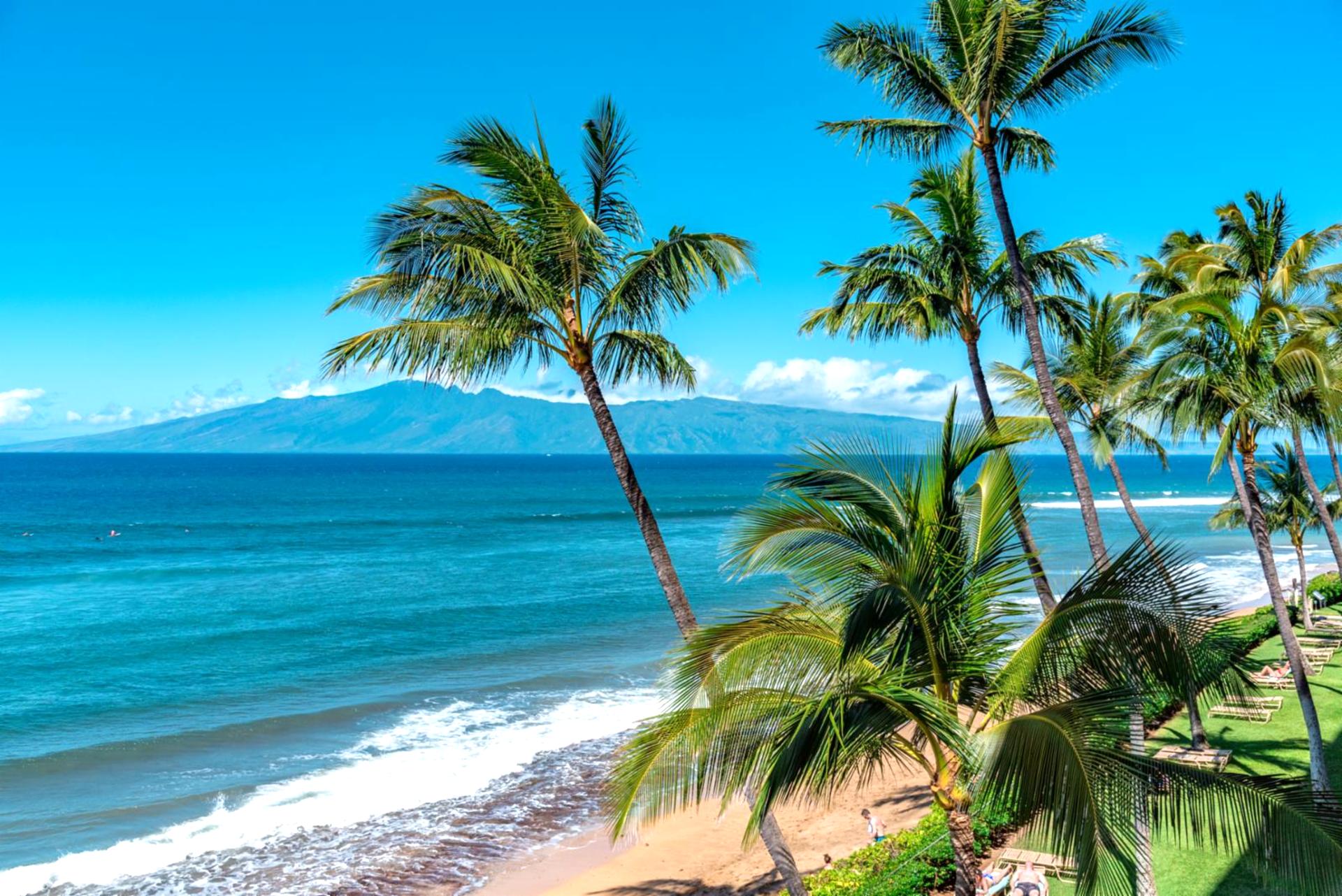 Relax in barefoot luxury where the gentle surf meets vibrant Hawaiian skies