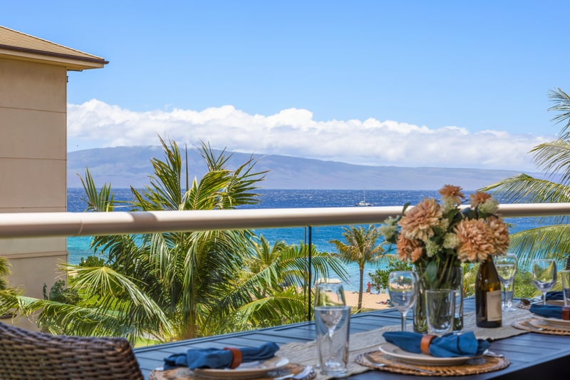 Palm trees sway, ocean waves play, and your table’s set for paradise on this stunning lanai