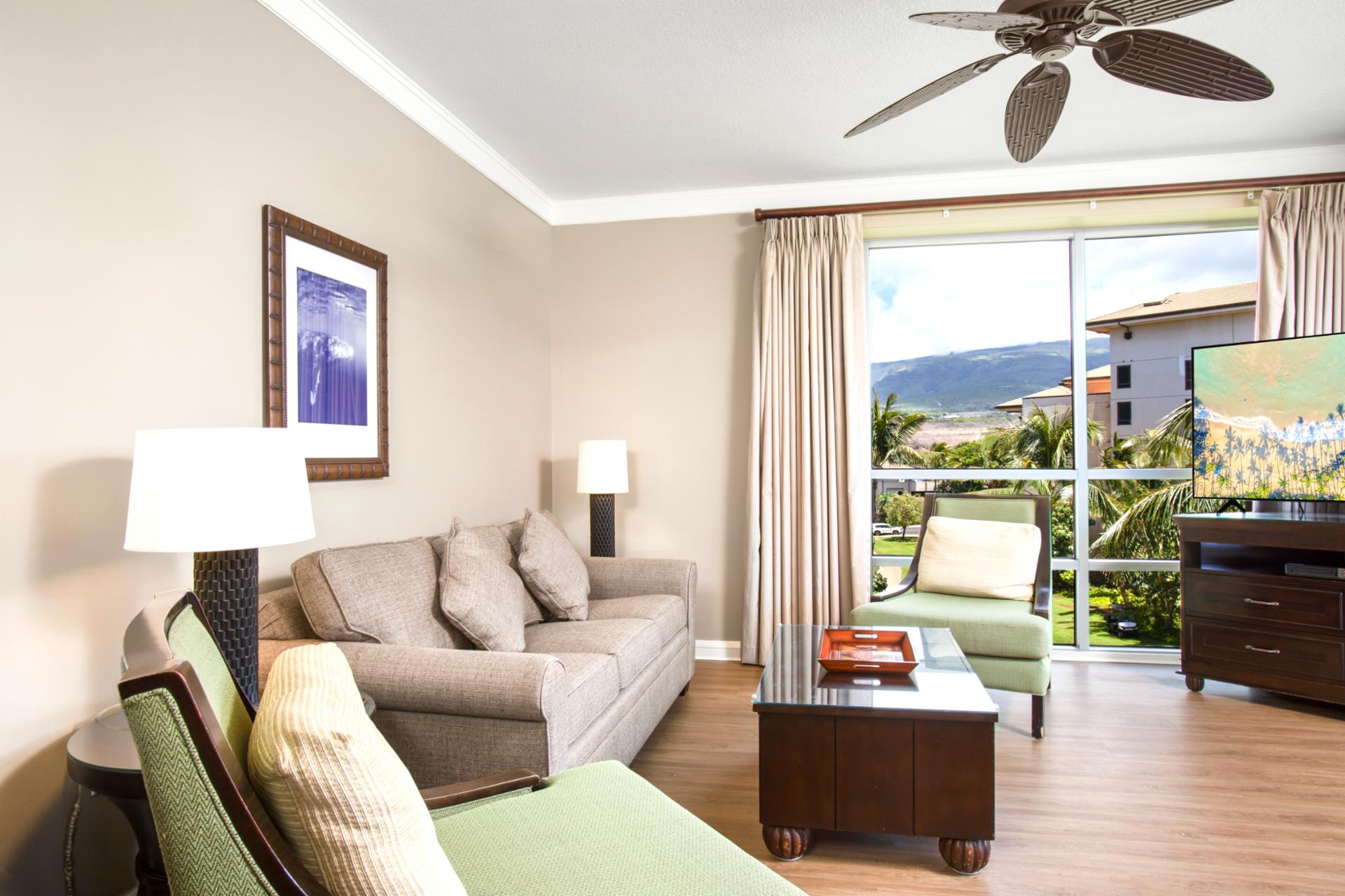 Relax in a sunlit living room with plush seating, warm tones, and views of lush palms and island skies