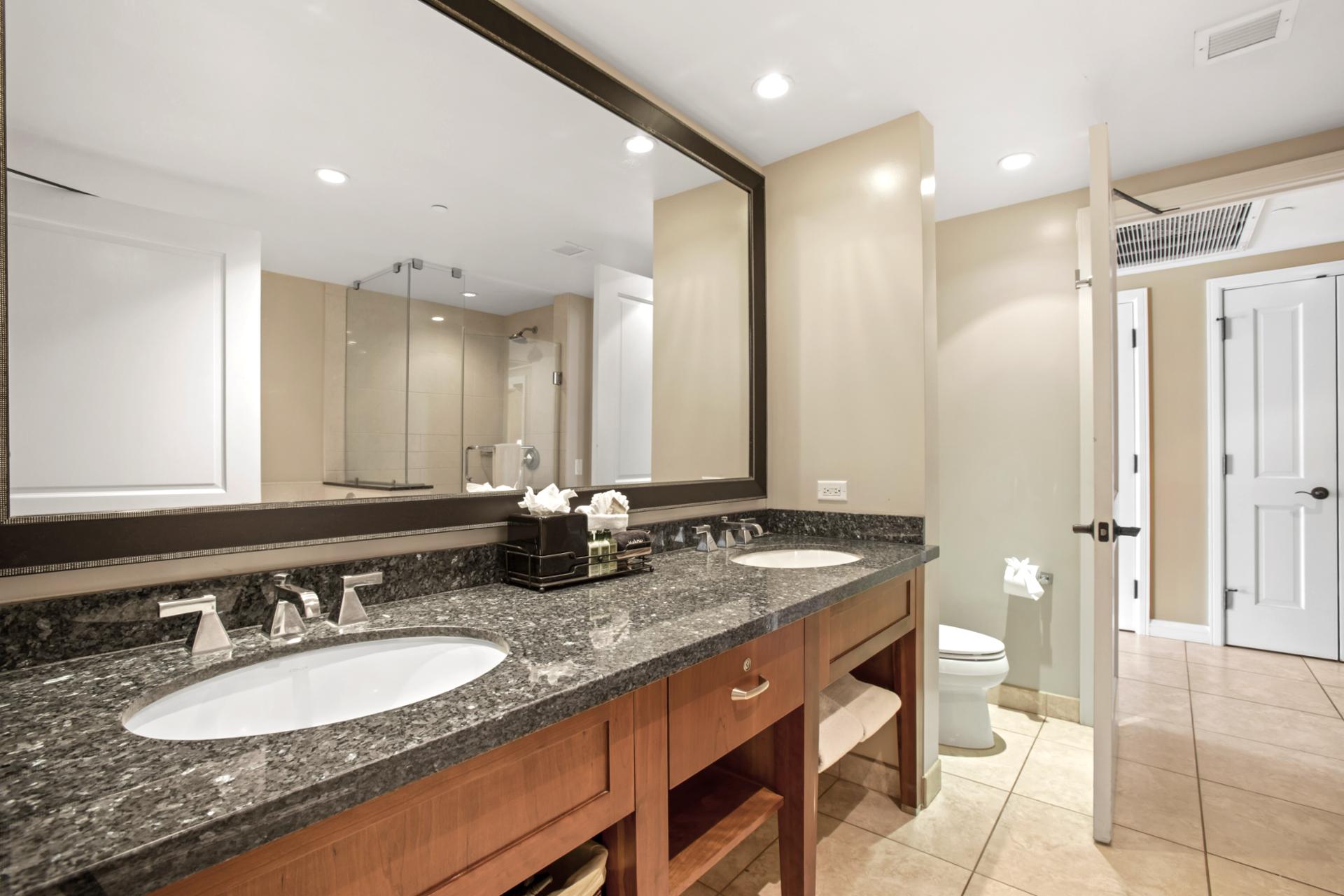 Clean, sophisticated, and well-lit, this primary bath blends utility with timeless design