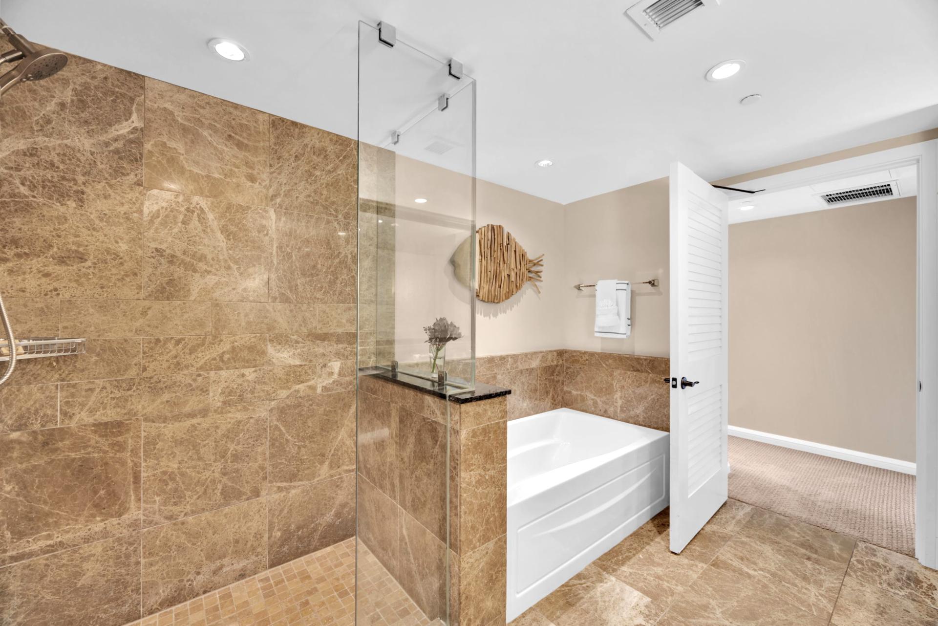 Step into a soothing shower space finished in natural stone
