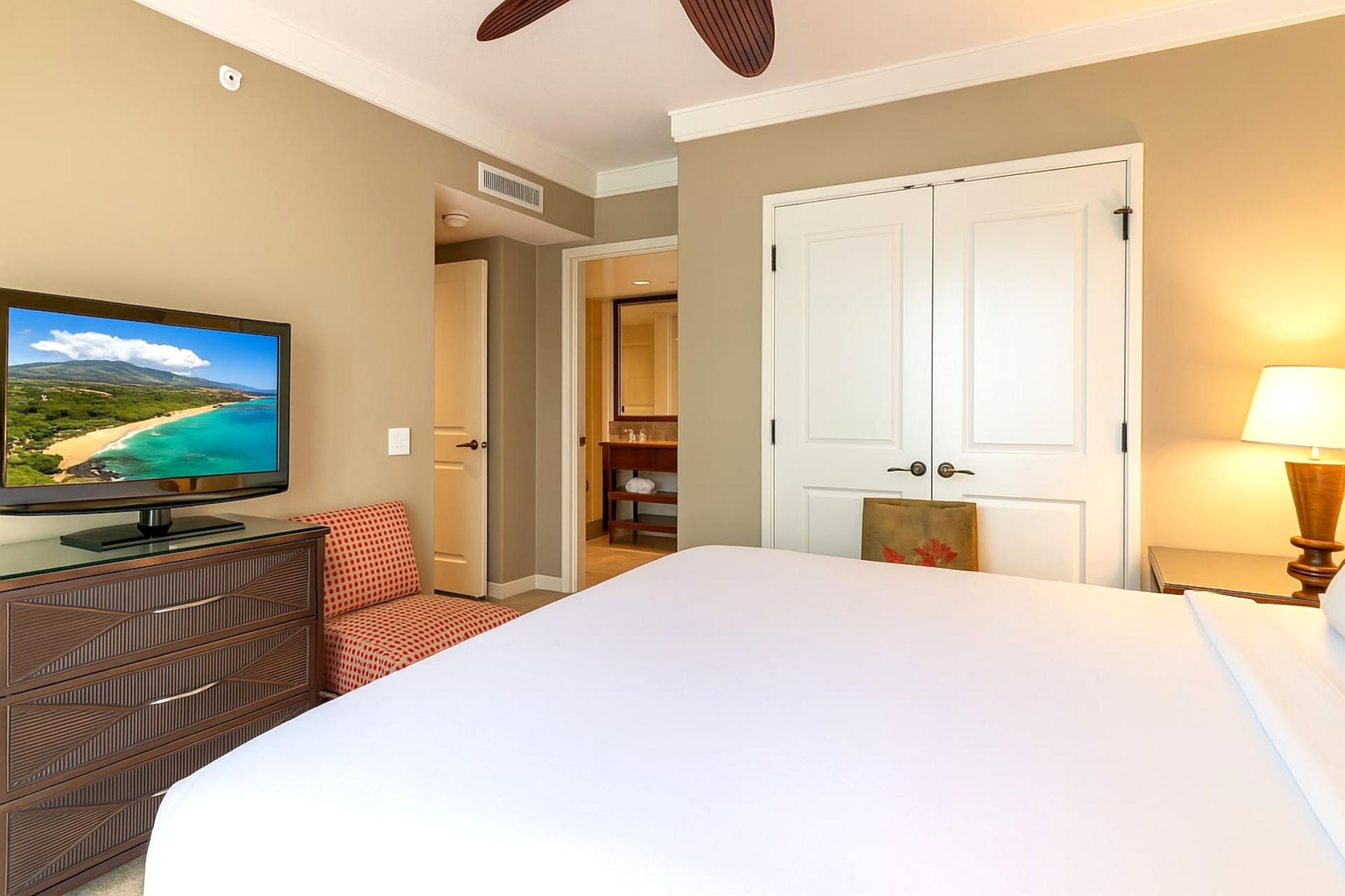 Elegant Escape: Neutral tones and modern furnishings make this master bedroom a restful haven.