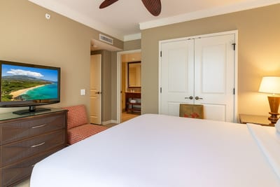 Elegant Escape: Neutral tones and modern furnishings make this master bedroom a restful haven.