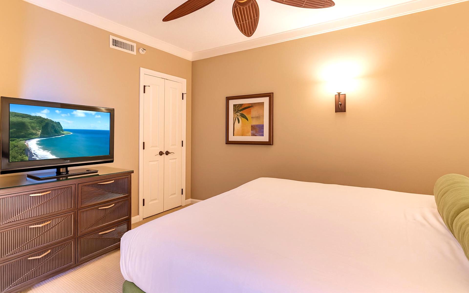 Tropical Tranquility: Unwind in the spacious bedroom featuring a cozy bed and calming decor