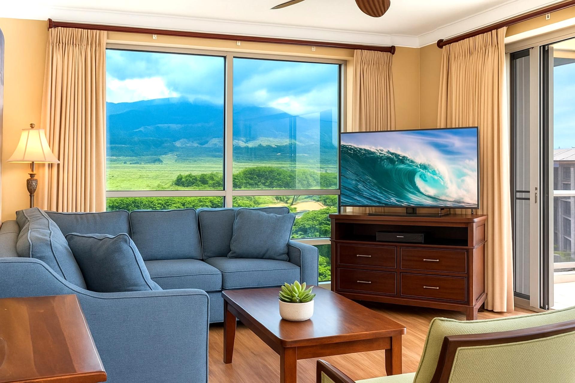 Spacious, sun-filled living room with panoramic floor-to-ceiling views of Maui's lush landscapes 