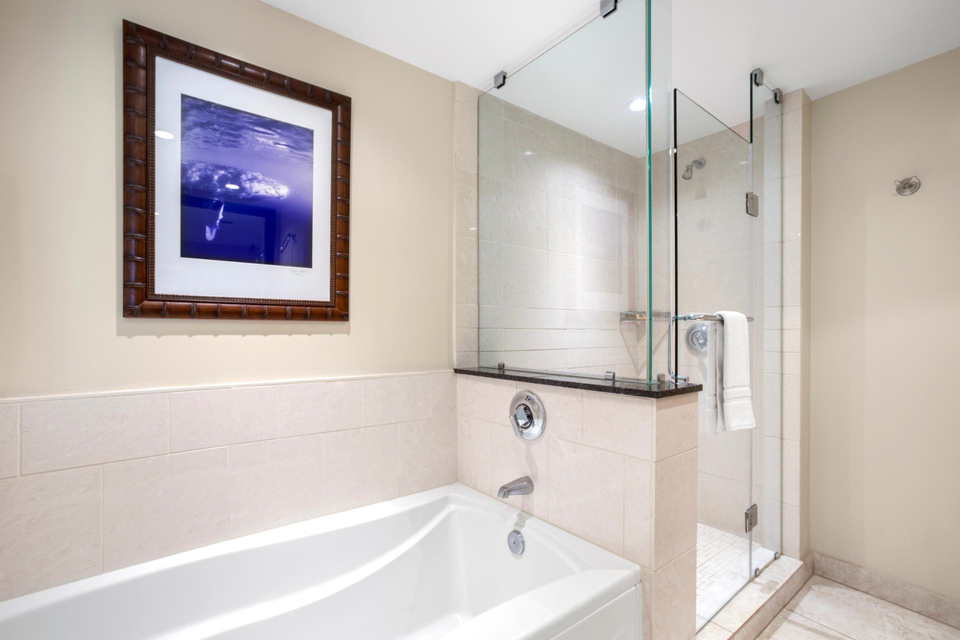 Elegant bathroom features soaking tub and glass shower for ultimate relaxation or quick rinses after tropical adventures 