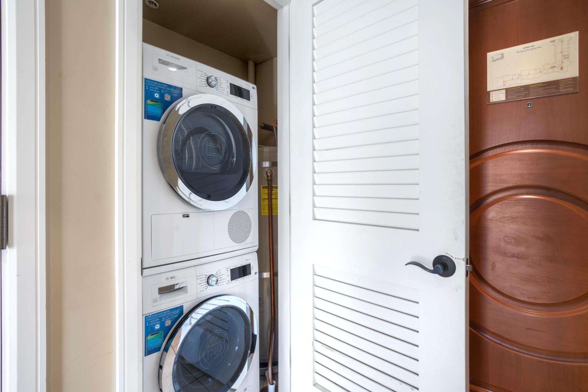 Compact laundry closet with modern stacked Bosch washer and dryer.