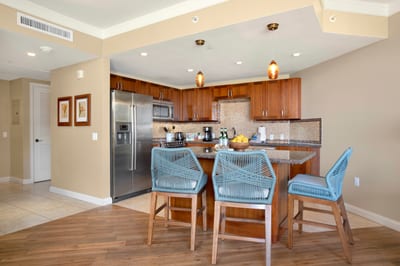Gather around the breakfast bar in this spacious, open-concept kitchen—perfect for morning coffee or evening cocktails