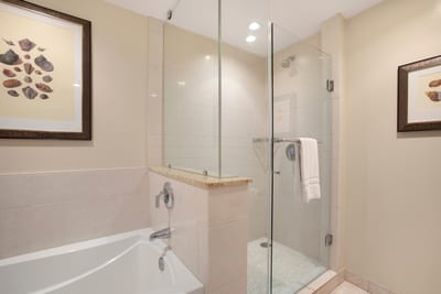 Refresh in a spa-inspired master bath featuring a glass walk-in shower and elegant tile finishes