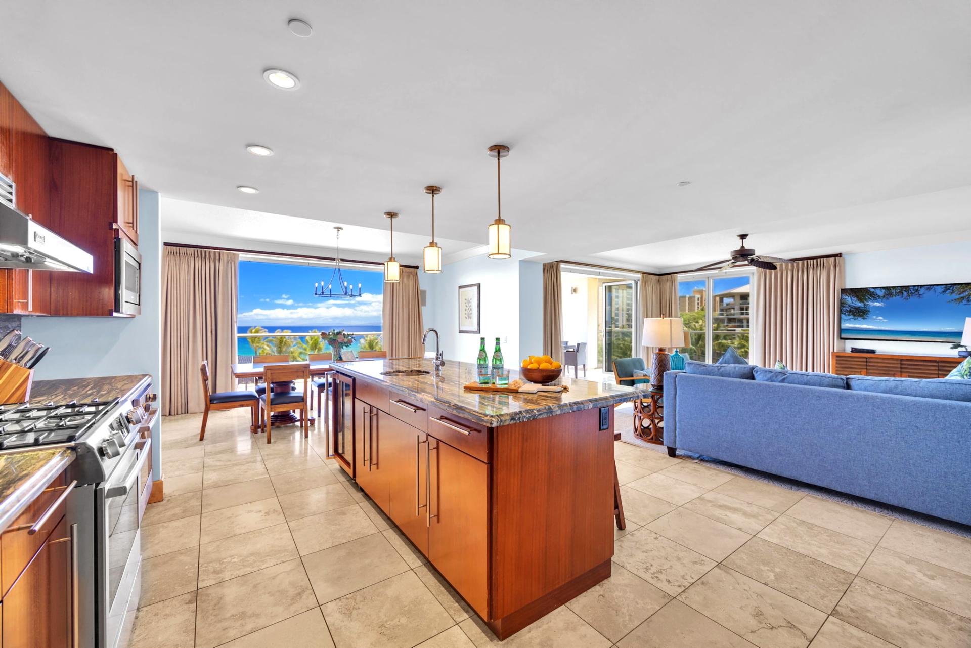 Expansive kitchen layout with large island bar and ocean glimpses.