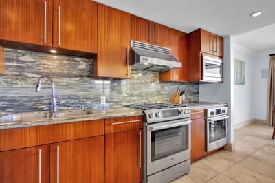 Warm wooden cabinetry and stainless steel appliances HKH-550