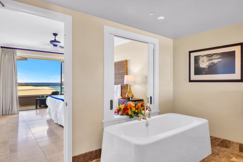 Master bath with a soaking tub, featuring ocean views 