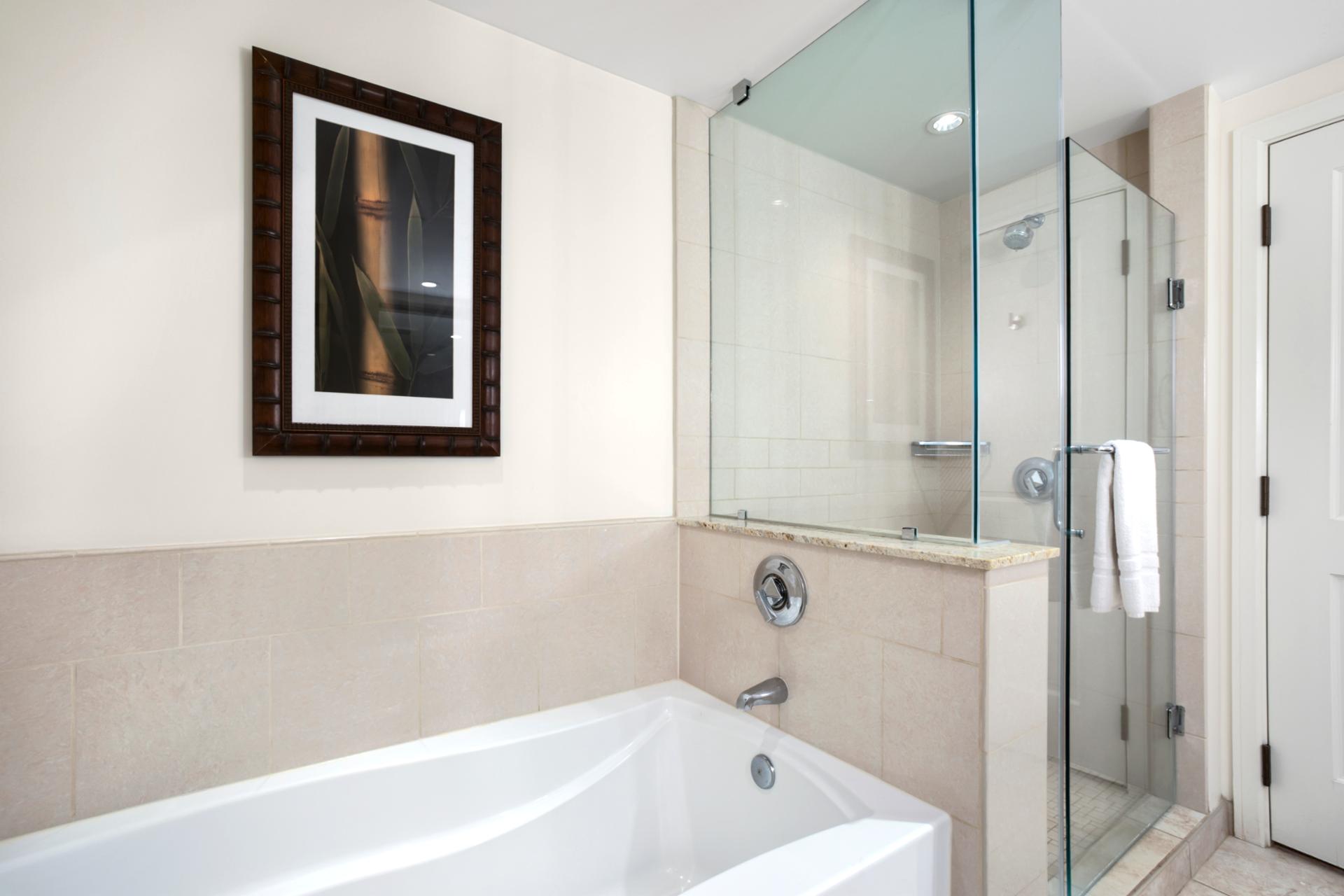 Spa-inspired bathroom with deep soaking tub and frameless glass shower.