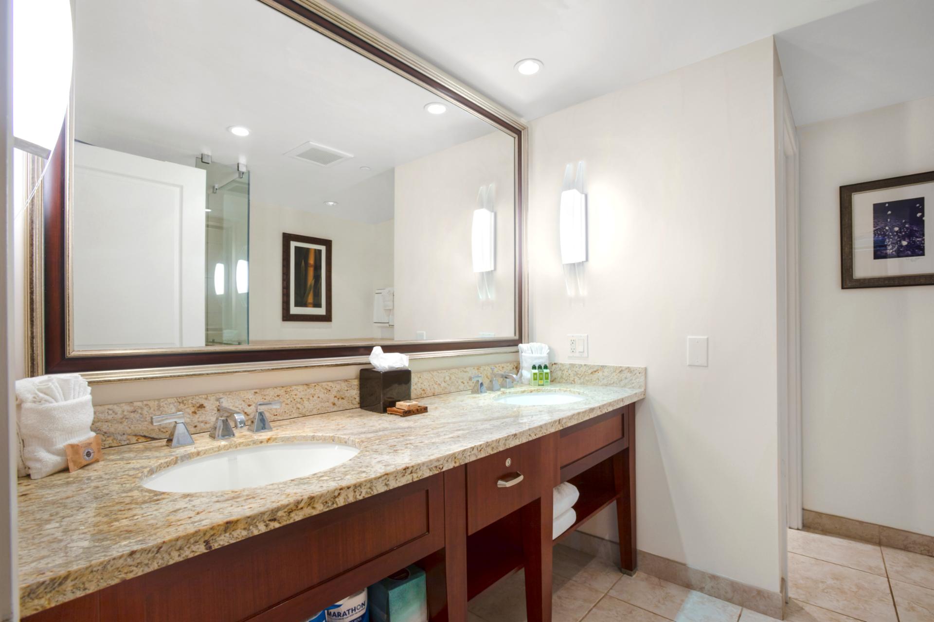 Double vanity bathroom with granite countertops and soft ambient lighting elegance.